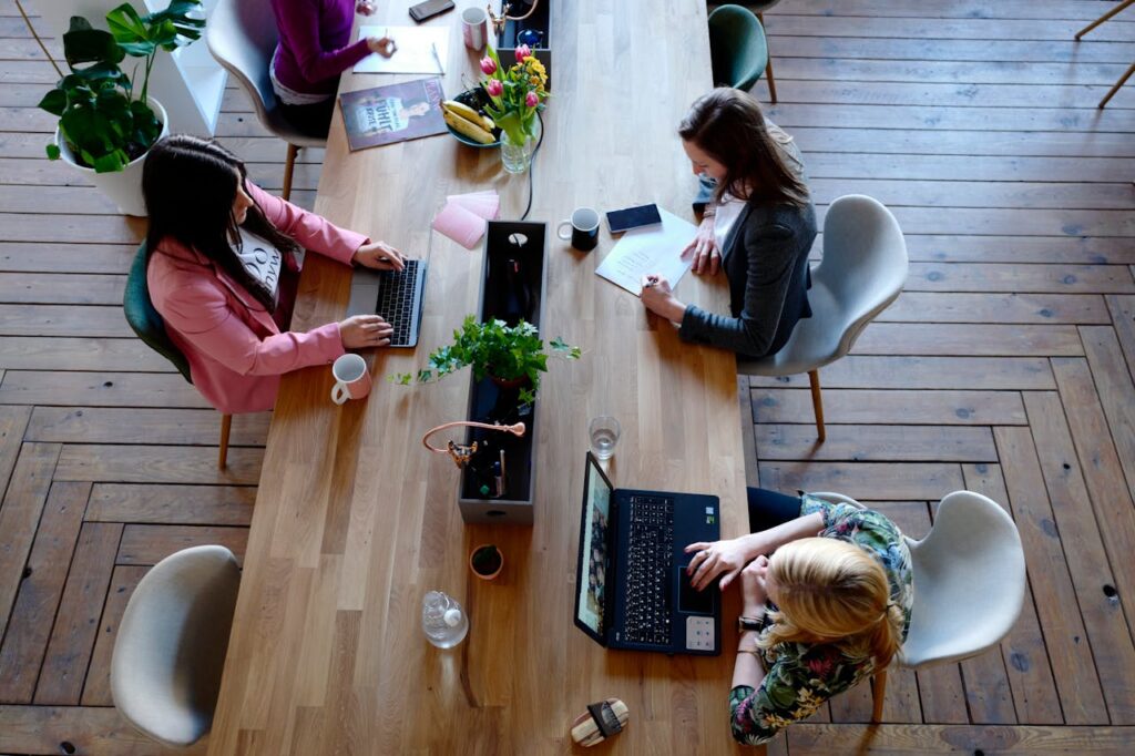 A group of women working in an office by a big table